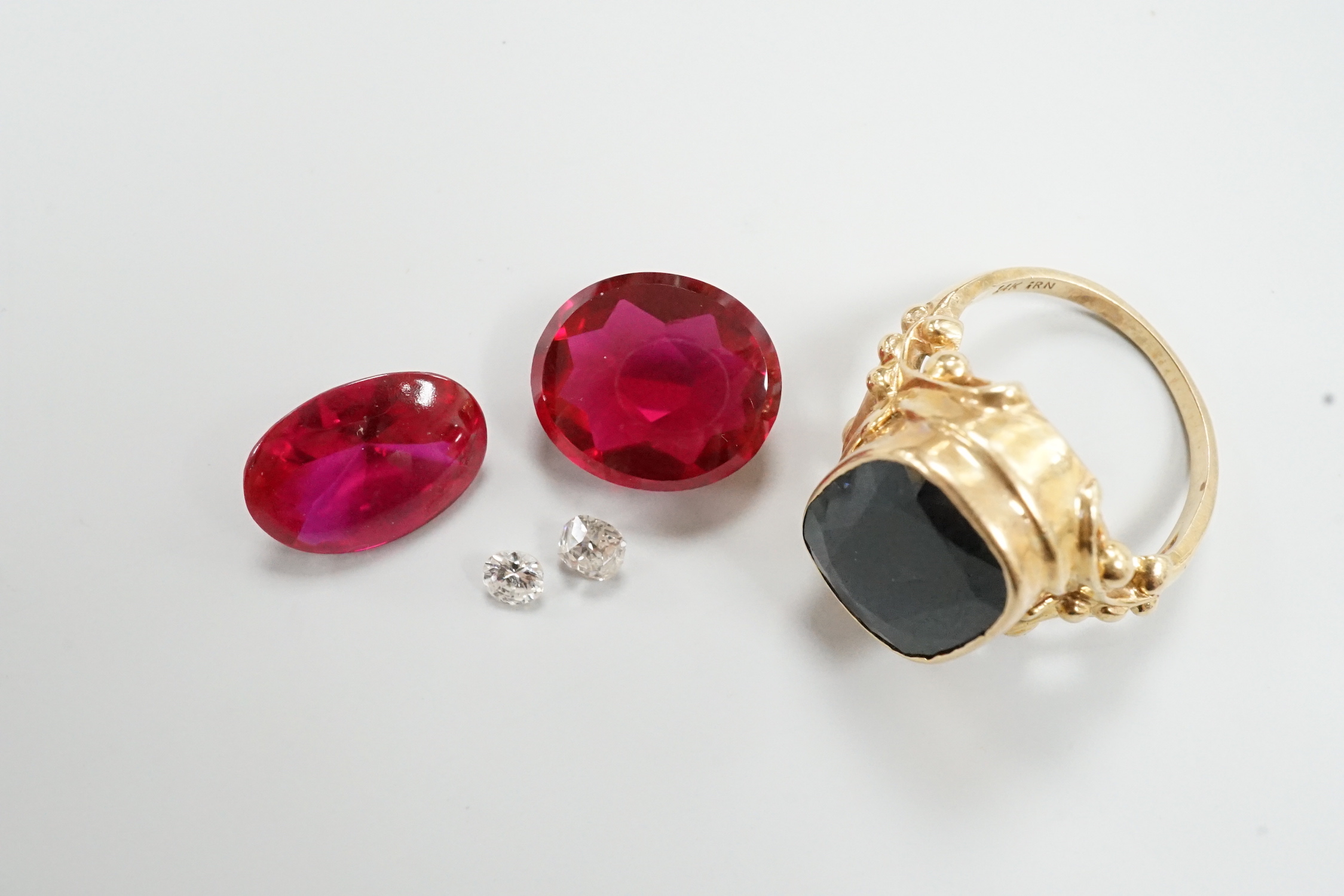 A 14k yellow metal and hematite? set signet ring, size K, gross weight 7.9 grams, together with four unmounted cut stones including two diamonds.